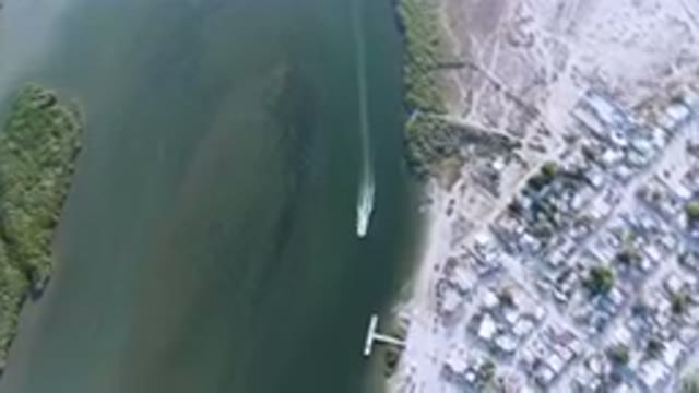 ALDOFO LOPEZ MATEOS BCS MEXICO-2023: Aerial Small Boat Traveling Through A Large Body Of Water