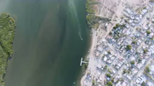 ALDOFO LOPEZ MATEOS BCS MEXICO-2023: Aerial View of Small Town With River and Plane