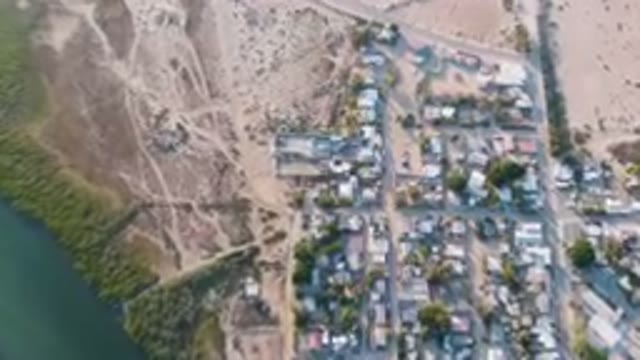 ALDOFO LOPEZ MATEOS BCS MEXICO-2023: Aerial View of Small Town With River Running