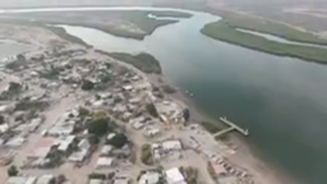 ALDOFO LOPEZ MATEOS BCS MEXICO-2023: Aerial City With A River And A Boat Dock