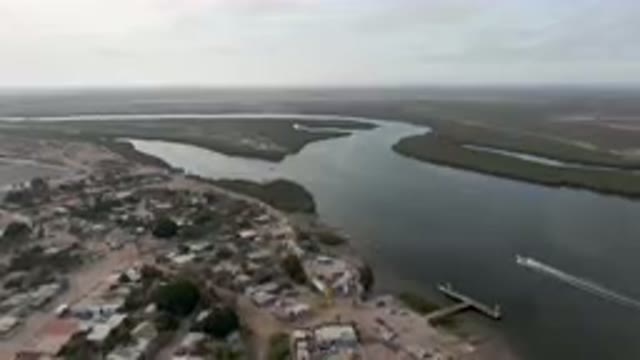 ALDOFO LOPEZ MATEOS BCS MEXICO-2023: Aerial River And A City With A Boat In The
