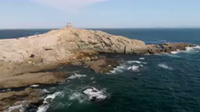 BAHIA ASCUNCION BCS MEXICO-2023: Rocky Coast With A Lighthouse On Top Of It