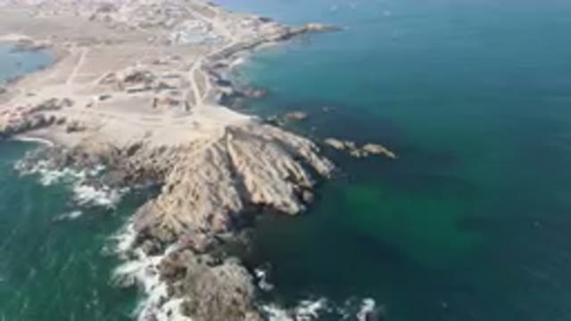 BAHIA ASCUNCION BCS MEXICO-2023: Aerial Rocky Coastline With A Beach And A Small Town