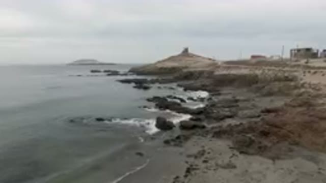 BAHIA ASCUNCION BCS MEXICO-2023: Rocky Beach With A Lighthouse In The Distance