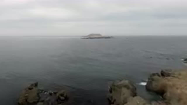 BAHIA ASCUNCION BCS MEXICO-2023: Small Boat Out On The Water Near A Rocky Shore