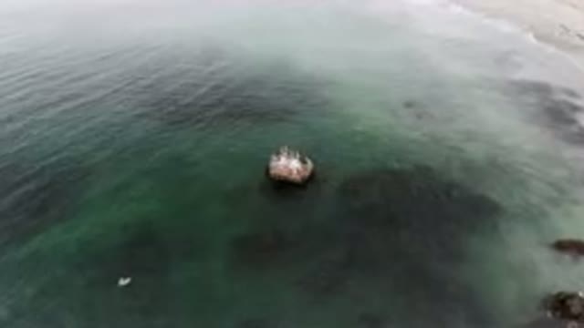 BAHIA ASCUNCION BCS MEXICO-2023: Boat Floating Near Rock in Coastal Waters