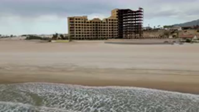 SAN FELIPE BC MEXICO-2023: Large Building On The Beach With A Surfboard In The