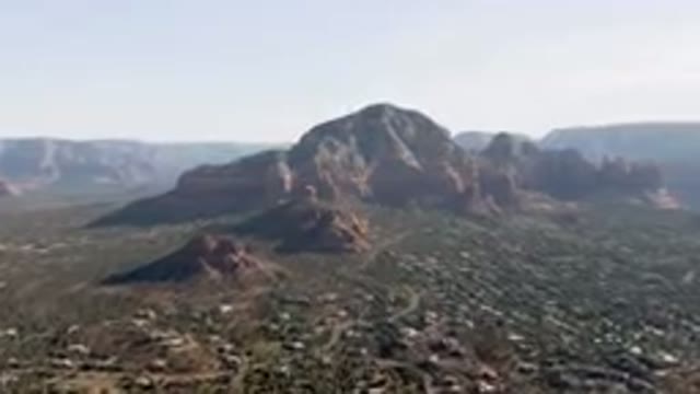 SEDONA ARIZONA USA-2023: Mountains In The Distance With A Town Below Them