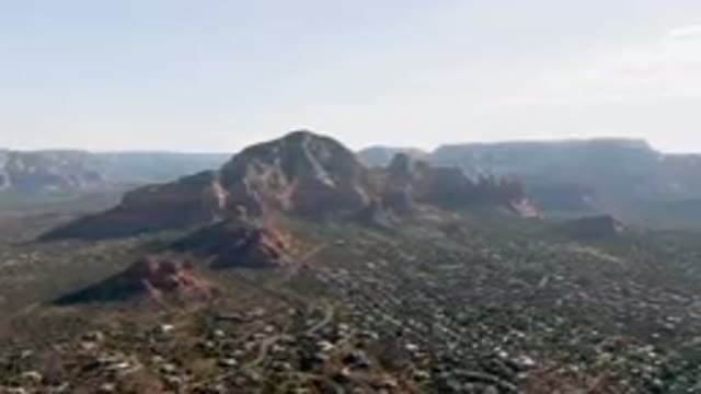 SEDONA ARIZONA USA-2023: Mountains With A Valley In The Foreground And A City