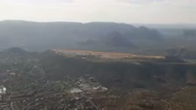 SEDONA ARIZONA USA-2023: Aerial City And Mountains With A Plane Flying Over It
