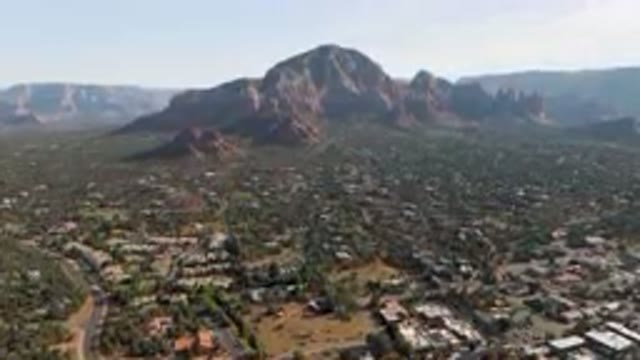 SEDONA ARIZONA USA-2023: Aerial View of Cathedral Rock Bluff with Mountains in Background