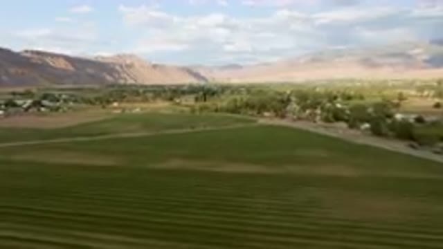 PALISADES COLORADO USA-2023: Green Field With A Road In The Middle