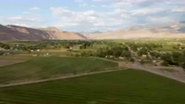 PALISADES COLORADO USA-2023: Green Field With A Road And A Mountain In The