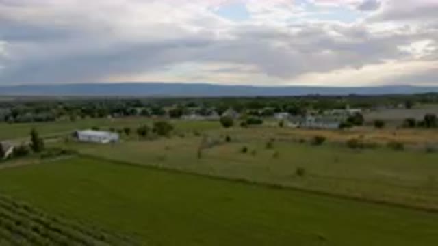 PALISADES COLORADO USA-2023: Large Field With A Farm And A Small Town In The Distance