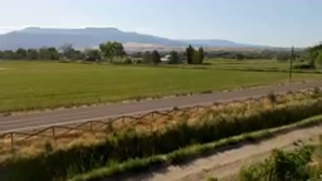 PALISADES COLORADO USA-2023: Long Road Next to a Field