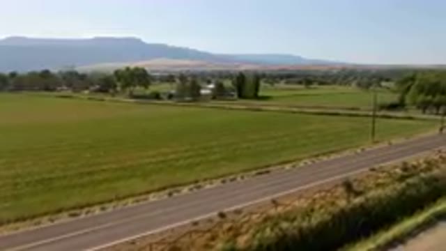 PALISADES COLORADO USA-2023: Field With A Road And A Mountain In The Distance