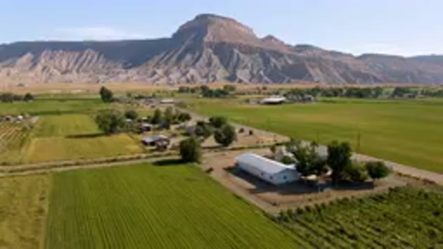 PALISADES COLORADO USA-2023: Aerial Farm With Mountain In Background