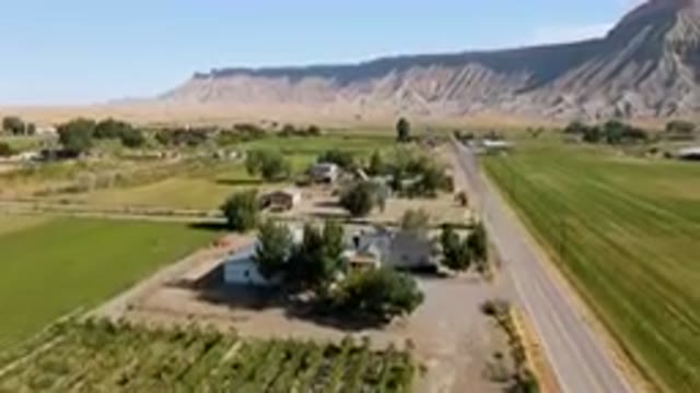 PALISADES COLORADO USA-2023: Aerial Farm With A Road And A Mountain In The Background