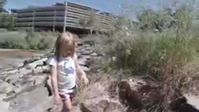 Denver, United States: Little Girl Climbing Rocks in the City. Denver, Colorado