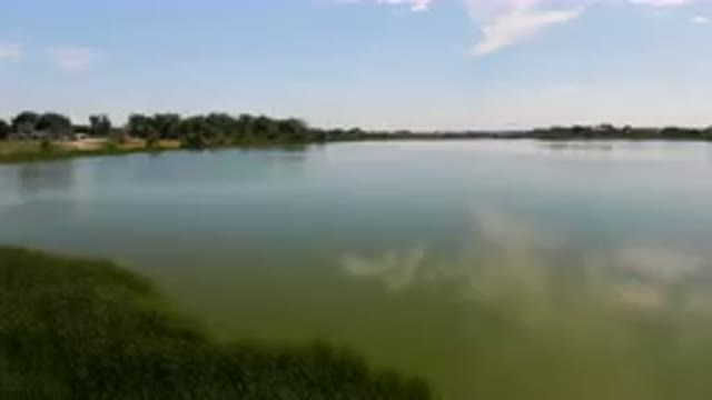 BROOMFIELD COLORADO USA-2023: Large Body Of Water With A Small Boat In It
