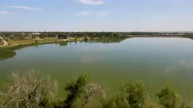 BROOMFIELD COLORADO USA-2023: Large Body Of Water With Trees In The Foreground