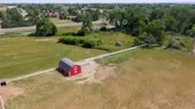 BROOMFIELD COLORADO USA-2023: Aerial Red Barn In A Field With A Road In The