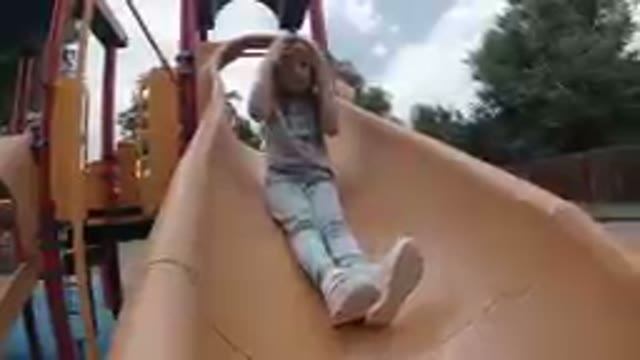 Denver, Colorado - 2019, Sept. 24 - Young Girl Going Down A Slide