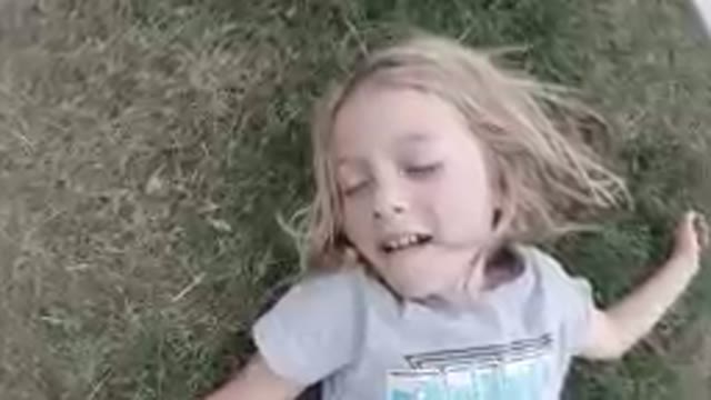SAN JOSE DEL CABO, MEXICO-2019: Little Girl Laying On The Grass With Her Eyes Closed