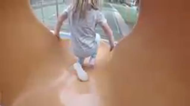 Denver, Colorado-2019, Sept.24-Long Hair Child Going Down A Slide
