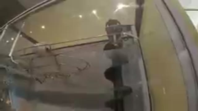 Glass Display Case With A Pair Of Shoes On It