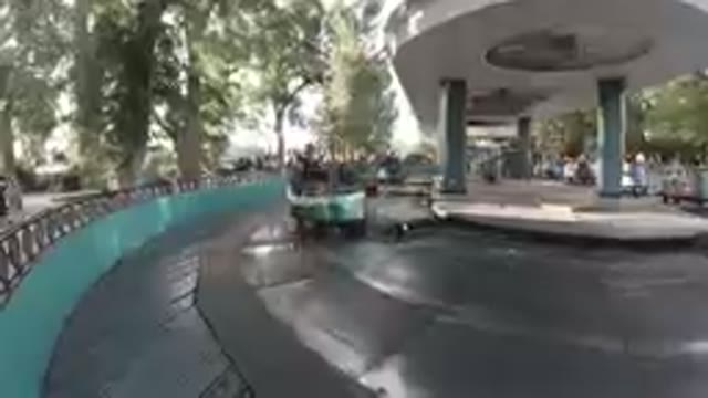 Happy Mom Displays Peace Sign While Riding Carousel