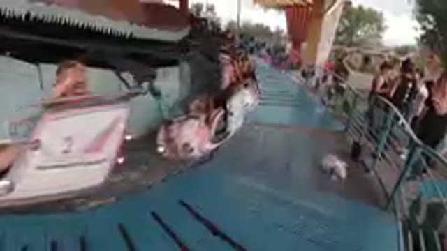Amusement Park: People Chilling on Airplane Carousel