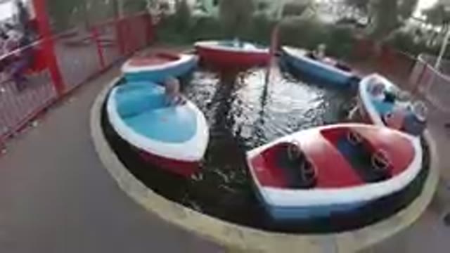 Amusement Park: Little Girl Enjoying The Speed Boat Carousel