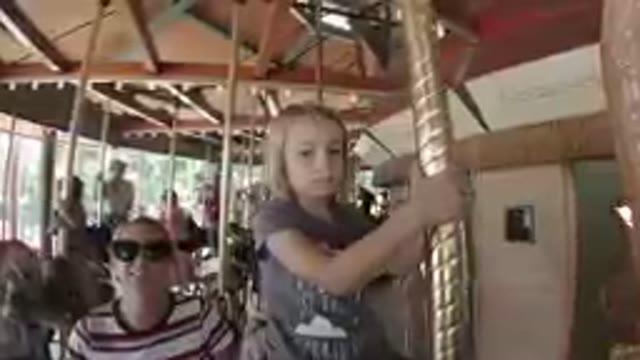 Amusement Park - Little Girl Riding Carousel
