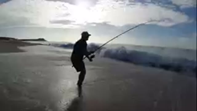 Fishing On The Beach With A Rod And A Hat