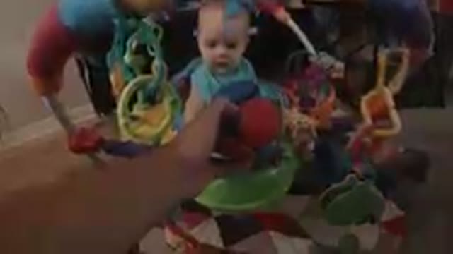 Baby Touching a Little Colored Ball