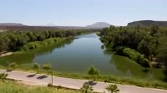 SAN IGNACIO BCS MEXICO-2023: River Running Through A Lush Green Valley