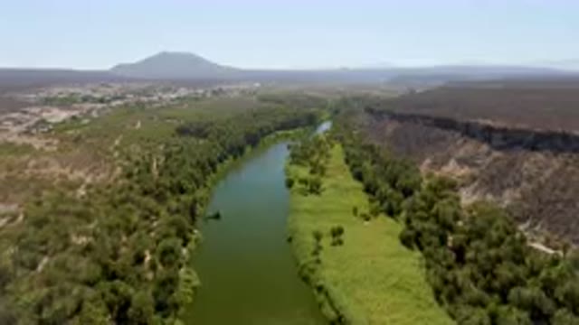 SAN IGNACIO BCS MEXICO-2023: River Running Through A Lush Green Valley