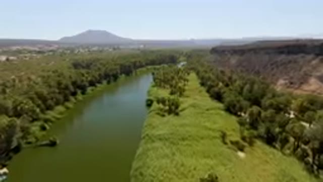 SAN IGNACIO BCS MEXICO-2023: River With A Boat In It And A Mountain In The Background