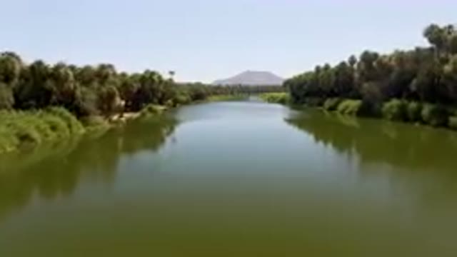 SAN IGNACIO BCS MEXICO-2023: River With Palm Trees And A Mountain In The