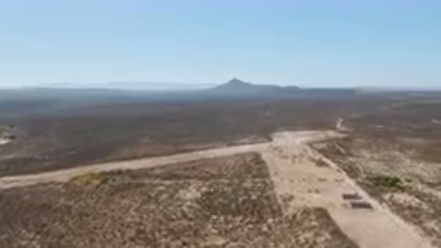 SAN IGNACIO BCS MEXICO-2023: Desert Landscape With Dirt Road And Giant Crater In Distance