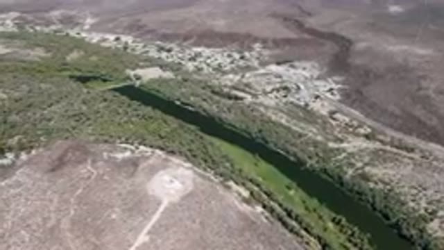 SAN IGNACIO BCS MEXICO-2023: Aerial River Running Through A Valley Surrounded By Trees