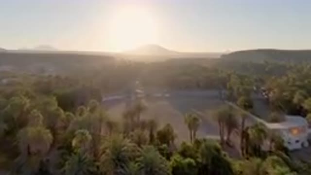 SAN IGNACIO BCS MEXICO-2023: Large Field With Palm Trees And A Church