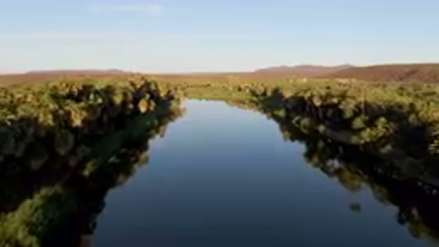 SAN IGNACIO BCS MEXICO-2023: River With Trees And Mountains In The Background