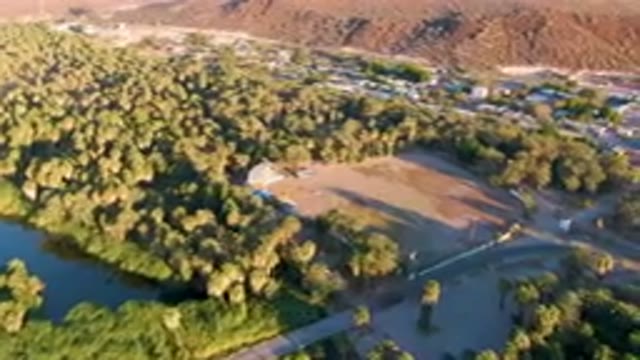SAN IGNACIO BCS MEXICO-2023: Aerial View of Small Town Surrounded by Trees and River