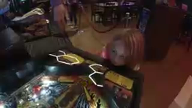 October 6, 2019. Denver, Colorado. Little Girl Observing a Pinball Machine