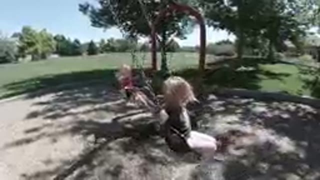 October 6, 2019. Denver, Colorado. Little Girls Swinging Happily
