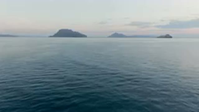 DANZANTE BAY LORETO BCS MEXICO-2023: Boat That Is Out In The Water Near Some Islands On Horizon