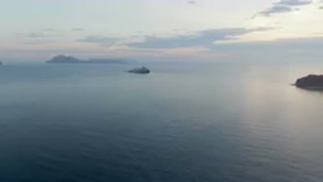 DANZANTE BAY LORETO BCS MEXICO-2023: Large Body Of Water With A Boat In It