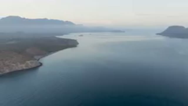 DANZANTE BAY LORETO BCS MEXICO-2023: Body Of Water With A Mountain In The Background